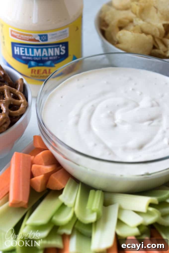 Luscious Onion Swirl 2 A vibrant platter of fresh vegetables arranged around a bowl of creamy onion dip, perfect for healthy snacking.