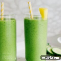 Tropical Cucumber Oasis Smoothie 2 cucumber smoothie garnished with pineapple