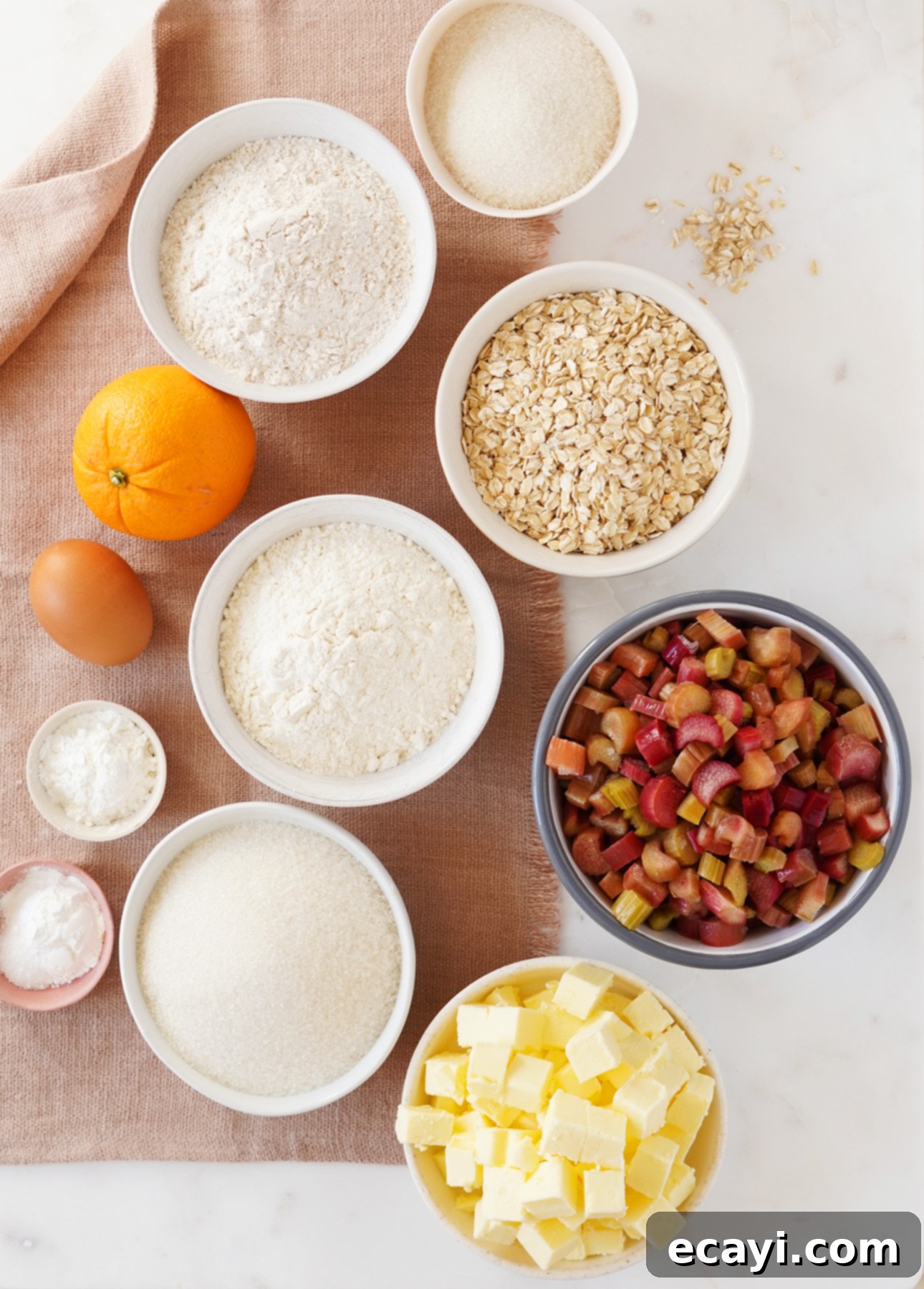 Sunshine Rhubarb Orange Crumble Bars 6 All the fresh and dry ingredients laid out on a table, ready to be combined to make Orange Rhubarb Crumb Bars. // FoodNouveau.com