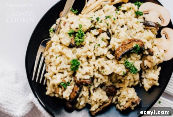 Looking for a cozy dinner that breaks from your usual routine while also being a total classic sure to please everyone? Meet Creamy Mushroom Risotto! risotto on plate with mushrooms