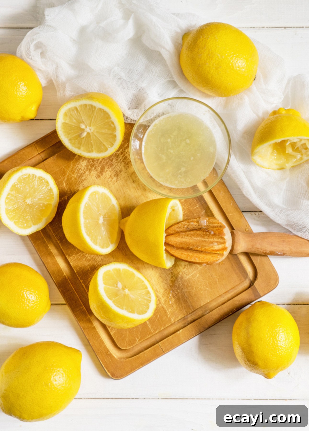 Zesty Citrus Cocktails: 25 Refreshing Recipes to Escape the Heat 3 Close-up of fresh lemons being squeezed for lemon juice, a key ingredient in many refreshing summer cocktails and citrus drinks.