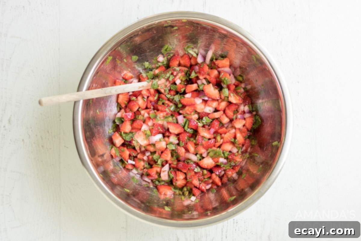 Summer Strawberry Salsa 6 A close-up view of the strawberry salsa, perfectly mixed and vibrant in a large silver bowl, ready to be served or chilled.