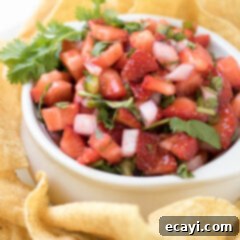 Summer Strawberry Salsa 8 A close-up of a bowl filled with fresh, vibrant strawberry salsa, highlighting its chunky texture and appealing colors.