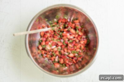 Summer Strawberry Salsa 10 A close-up view of the strawberry salsa, perfectly mixed and vibrant in a large silver bowl, ready to be served or chilled.