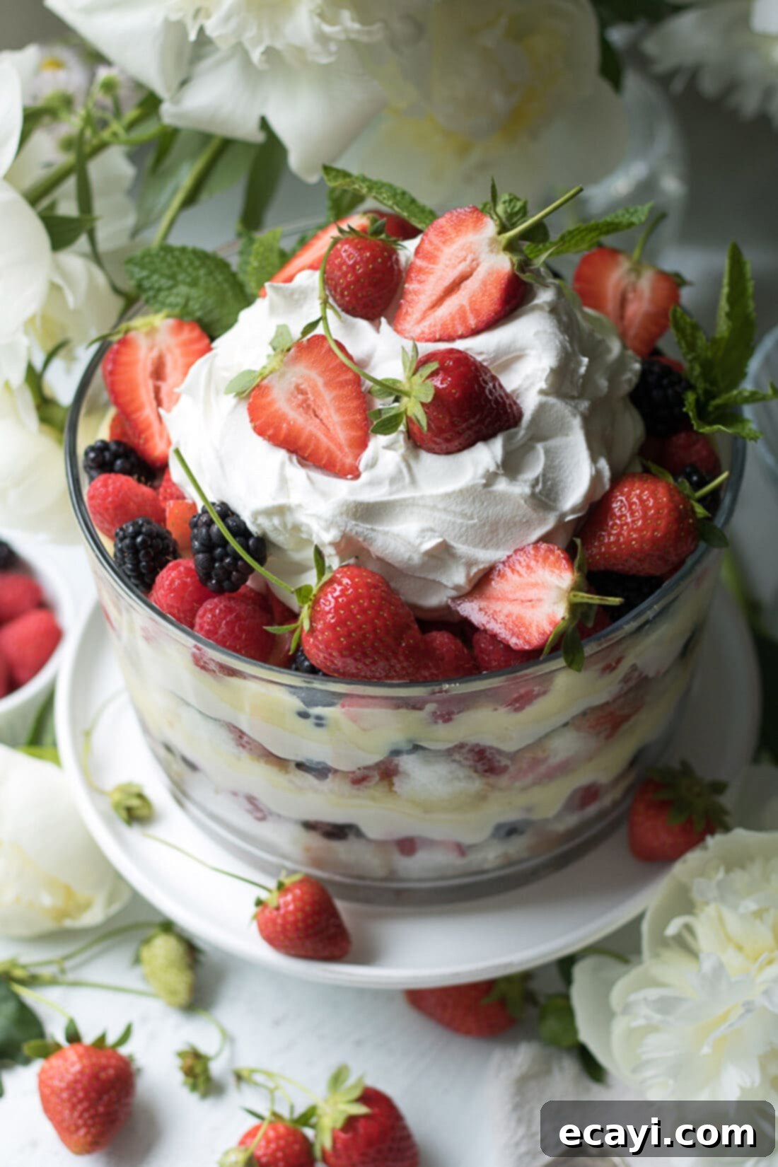 Garnished Mixed Berry Trifle from above. Top down view of a Mixed Berry Trifle, garnished with fresh berries and mint leaves.