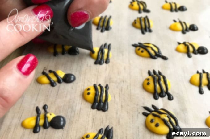 Sweet Honeybee Crowns 6 Close-up view of a yellow candy melt bee body with black candy melt eyes being added