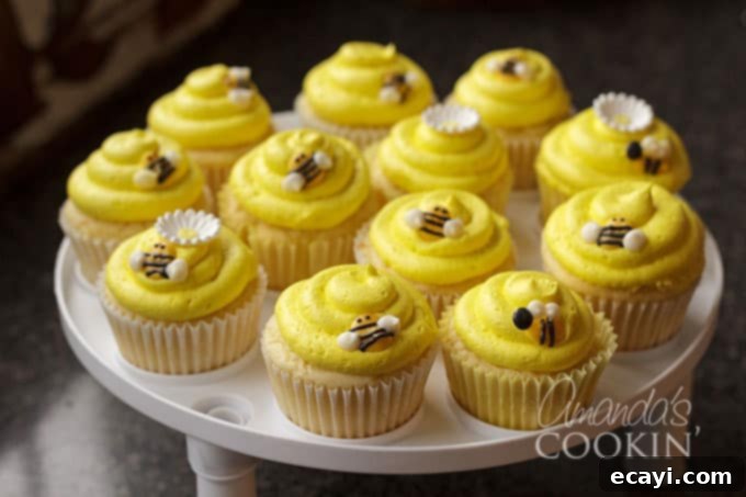 Sweet Honeybee Crowns 8 A batch of freshly baked cupcakes topped with homemade candy melt bee toppers and yellow frosting