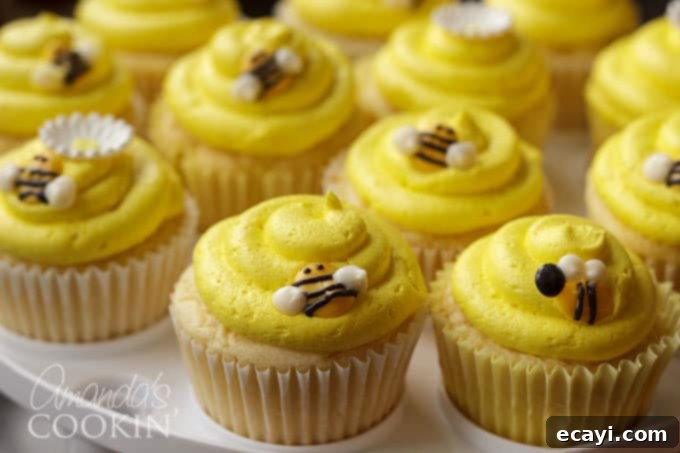 Sweet Honeybee Crowns 9 A beautifully decorated cupcake with yellow frosting and a DIY candy melt bee topper