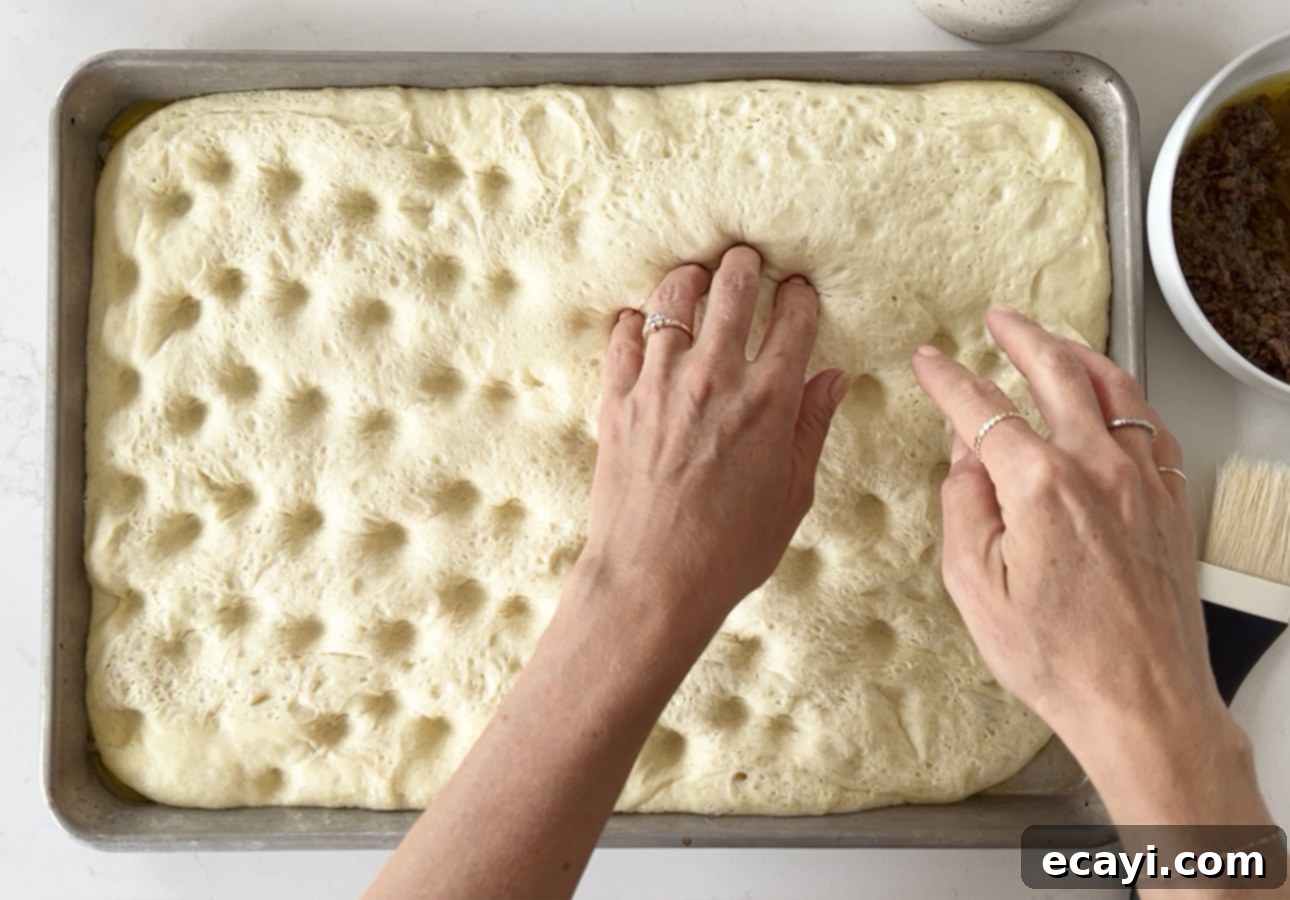 Golden Perfection Pissaladière A Provençal Onion and Anchovy Flatbread 20 Creating indentations in Provençal flatbread using finger tips // FoodNouveau.com