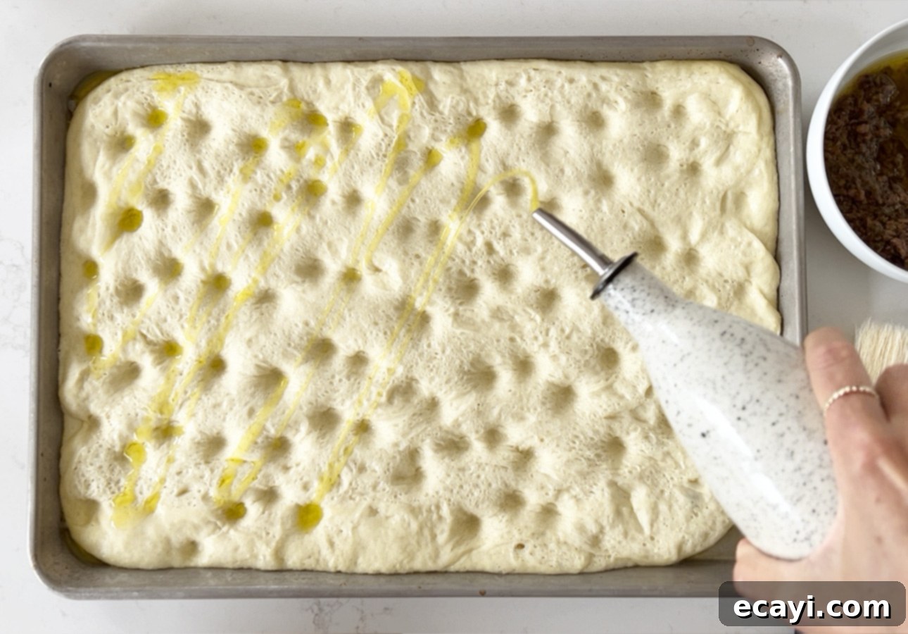 Golden Perfection Pissaladière A Provençal Onion and Anchovy Flatbread 21 Drizzling pissaladière dough with extra-virgin olive oil // FoodNouveau.com