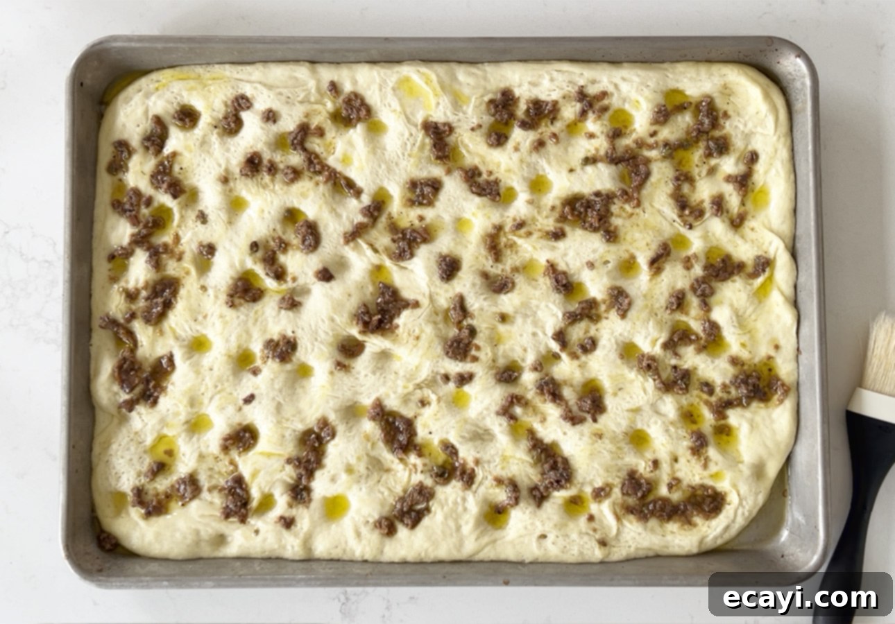 Golden Perfection Pissaladière A Provençal Onion and Anchovy Flatbread 23 Spreading anchoïade all over the dough for making Provençal flatbread // FoodNouveau.com