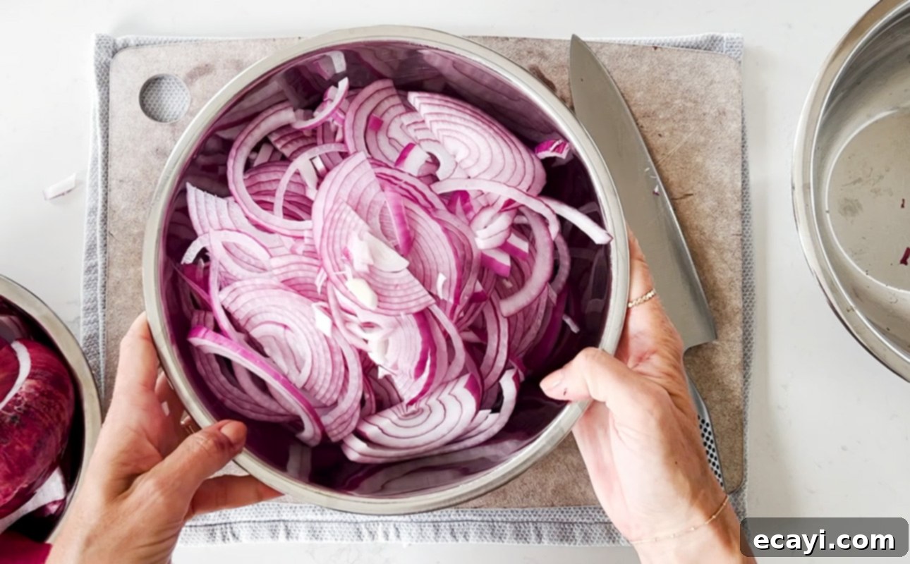 Golden Perfection Pissaladière A Provençal Onion and Anchovy Flatbread 7 A bowl of sliced red onions // FoodNouveau.com