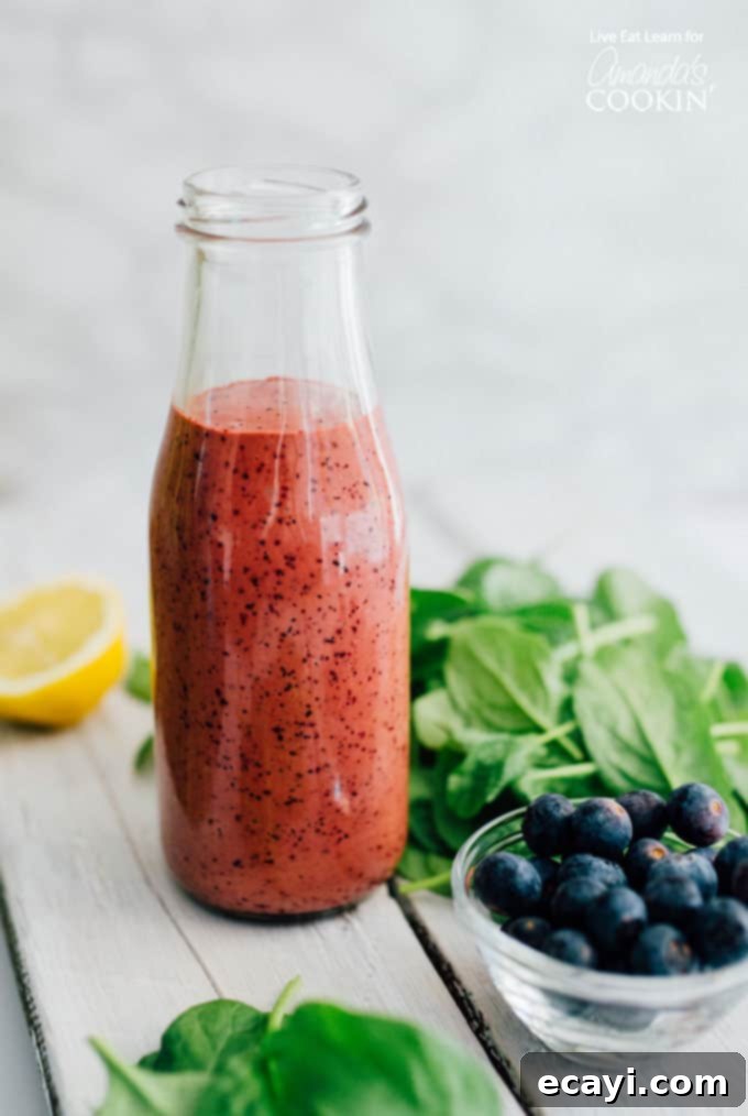 This homemade blueberry vinaigrette salad dressing is ready in just 5 minutes and requires only a handful of ingredients. Creamy, velvety blueberry dressing for healthy eating. Lush Blueberry Vinaigrette Salad Dressing in an elegant bottle, showcasing its rich, vibrant color and creamy texture, perfect for summer salads. Easy homemade recipe.
