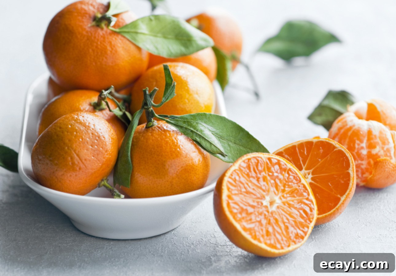Golden Glow 30 Savory Orange Recipes to Brighten Every Meal 3 A bowl of tangerine oranges with one fruit cut open // FoodNouveau.com