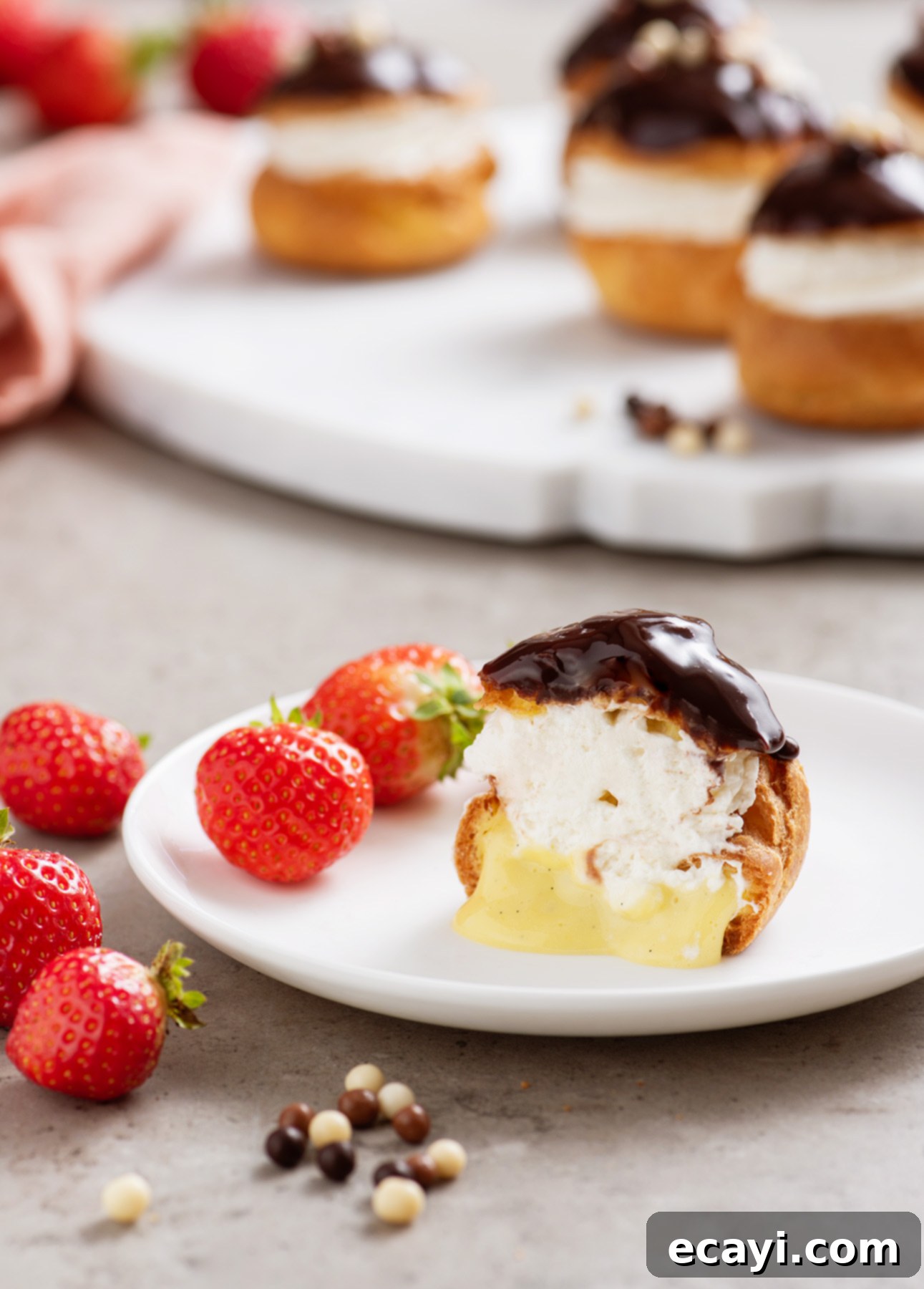 Bake Irresistible Cream Puffs 13 Beautifully assembled Classic Cream Puffs, featuring a dark chocolate glaze and creamy vanilla filling // FoodNouveau.com