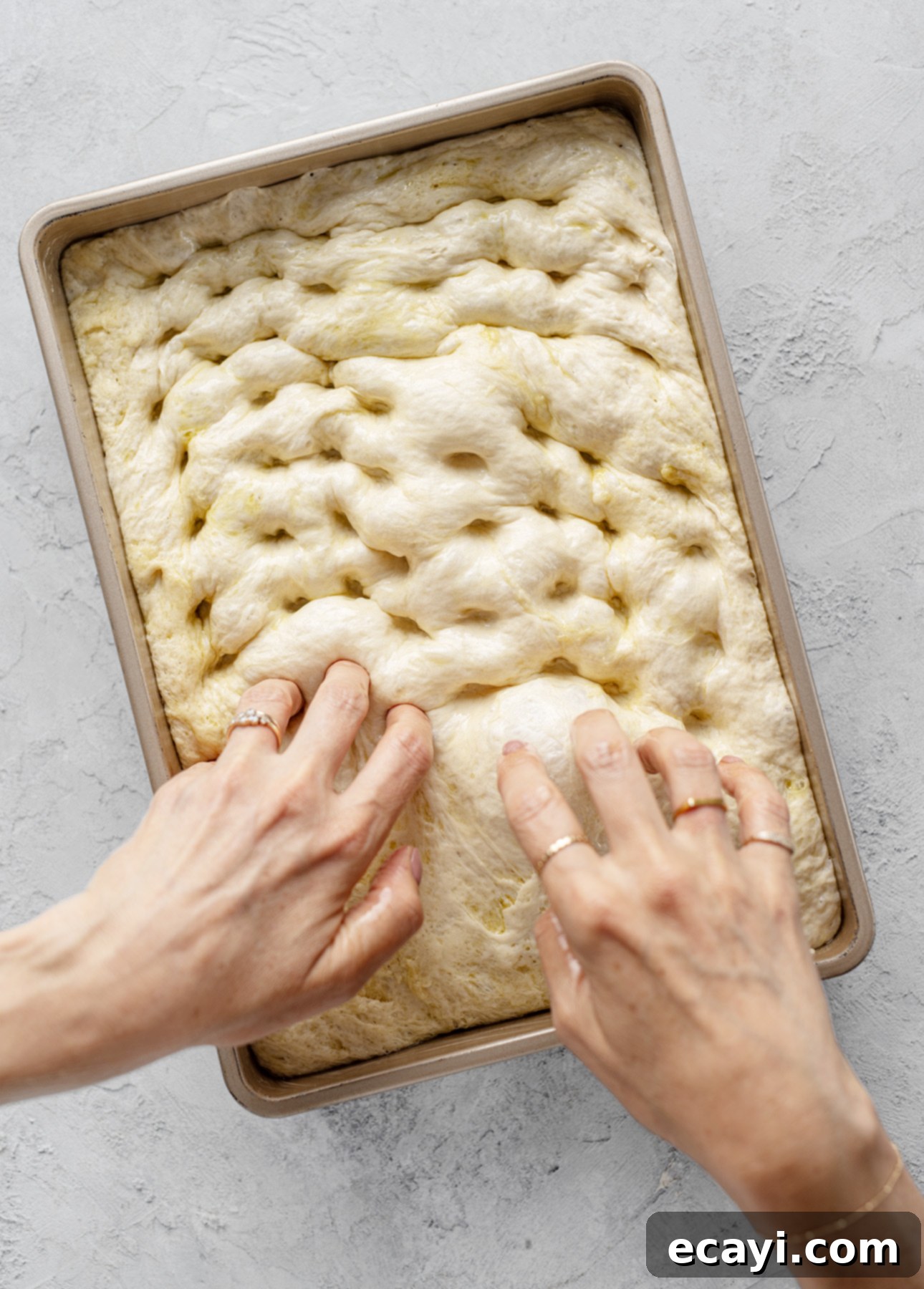 Bake Perfect No-Knead Focaccia Effortlessly 13 Creating dimples in the dough, perhaps the most satisfying step when making focaccia at home // FoodNouveau.com