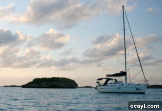 Our sailboat, the Congo, as the sun sets on Warderick Wells Cay. Our sailboat, the Congo, as the sun sets on Warderick Wells Cay. A breathtaking sunset over calm waters, with the silhouette of the sailboat against the vibrant sky.
