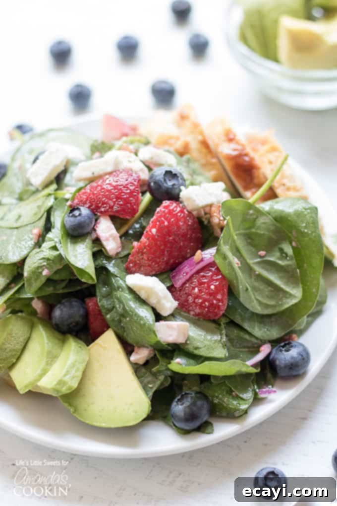 Easy, fresh, and delicious strawberry salad for summer Close-up of the delicious Strawberry Salad served on a plate, featuring fresh berries, greens, and a light dressing, highlighting its appealing colors.