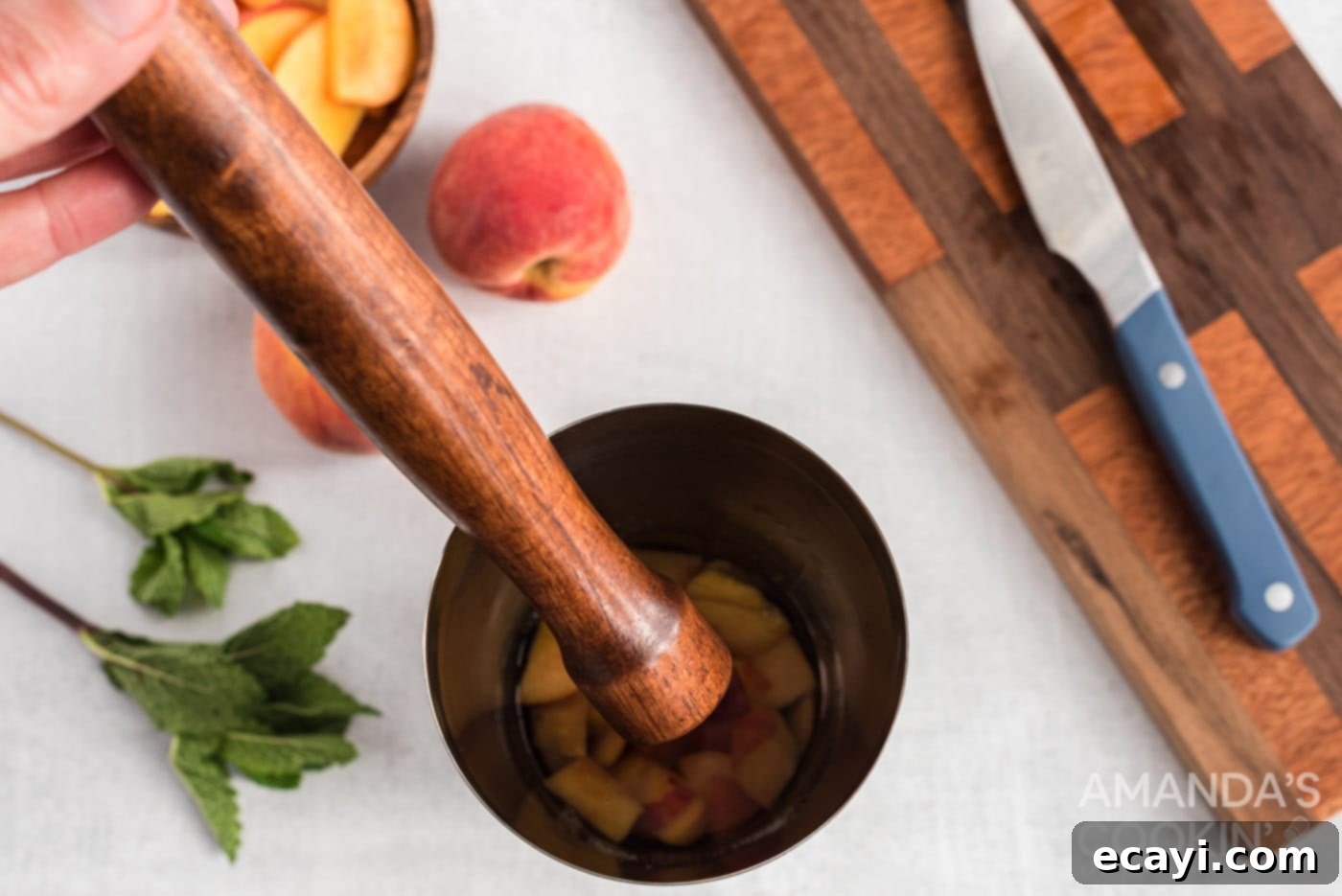 Peach Paradise Mojito 7 muddling peaches with rum and sugar
