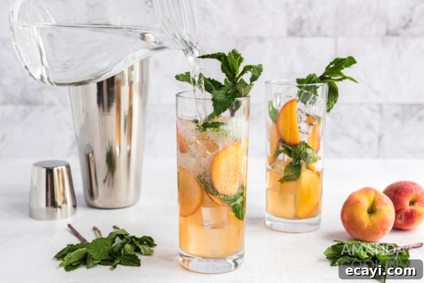 Peach Paradise Mojito 9 adding club soda to peach mojito in glass