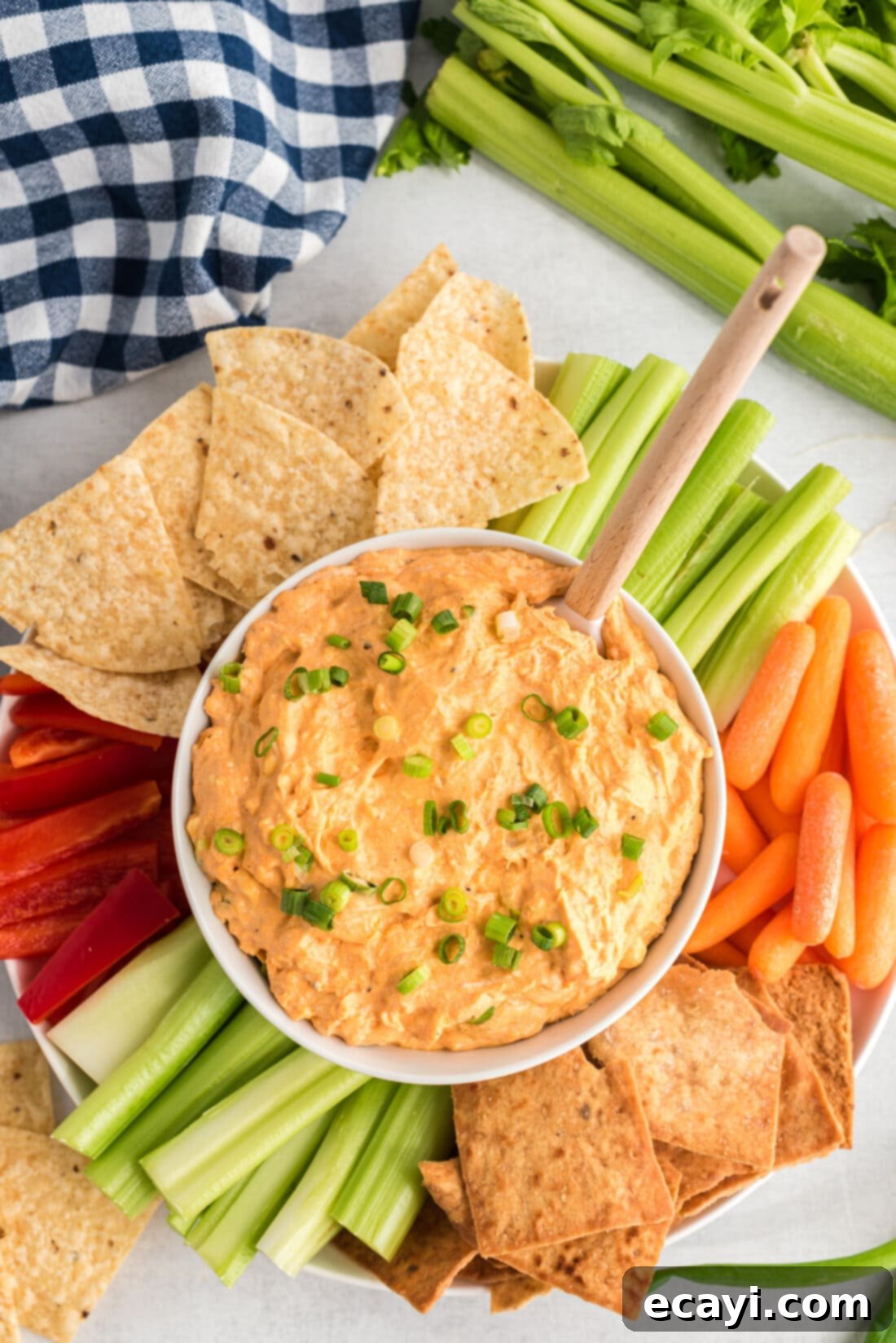 Ultimate Buffalo Chicken Dip 2 A large bowl of creamy, cheesy Buffalo Chicken Dip, ready to be scooped with tortilla chips, garnished with fresh chives.
