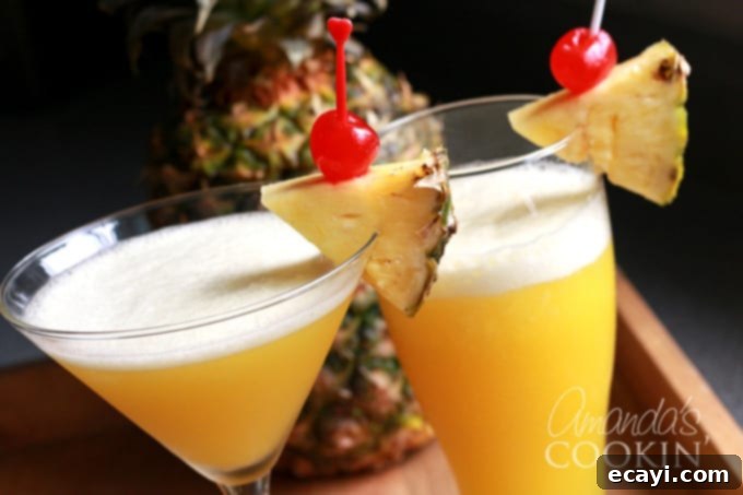 The Rum Cruiser Cocktail is a delicious blend of coconut rum, amber rum, banana liqueur, pineapple juice and orange juice. It's similar to a Rum Runner, but without the blackberry liqueur and grenadine. #comebacknew #cruisecocktail #alaskancruise #princesscruises #mixeddrinks #drinkswithrum #sponsored rum cruiser cocktails in elegant glasses with garnish