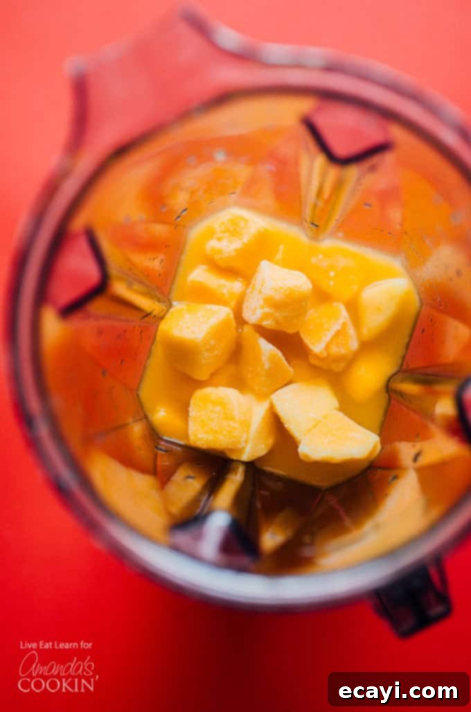 Step 1: Add frozen mangoes to the blender for the perfect slush Frozen mangos in a blender