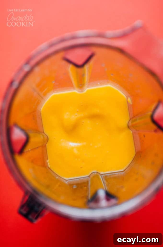 Step 2: Blend ingredients until smooth for a frosty mango margarita Mango margarita slush blending in a blender