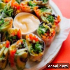 Vibrant Fiesta Rolls 2 summer rolls on a plate with dip in the center