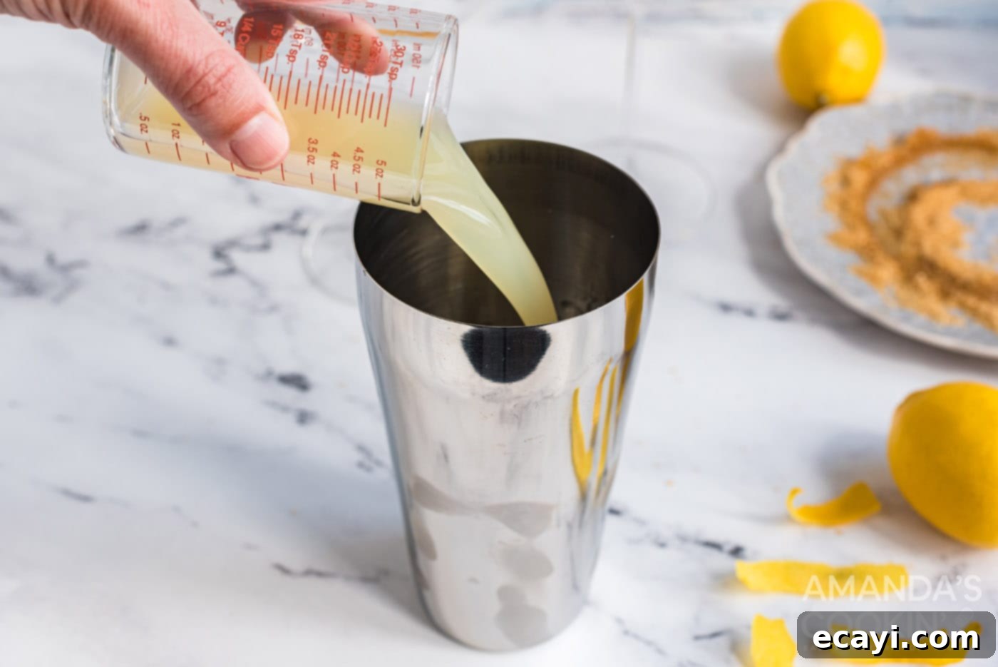 Sweet Tart Twinkle 7 Pouring fresh lemon juice into a cocktail shaker.