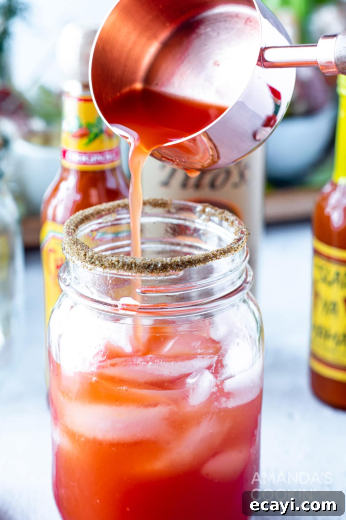 The Curse of Bloody Mary 7 Pouring tomato juice into a jar for a Bloody Mary.