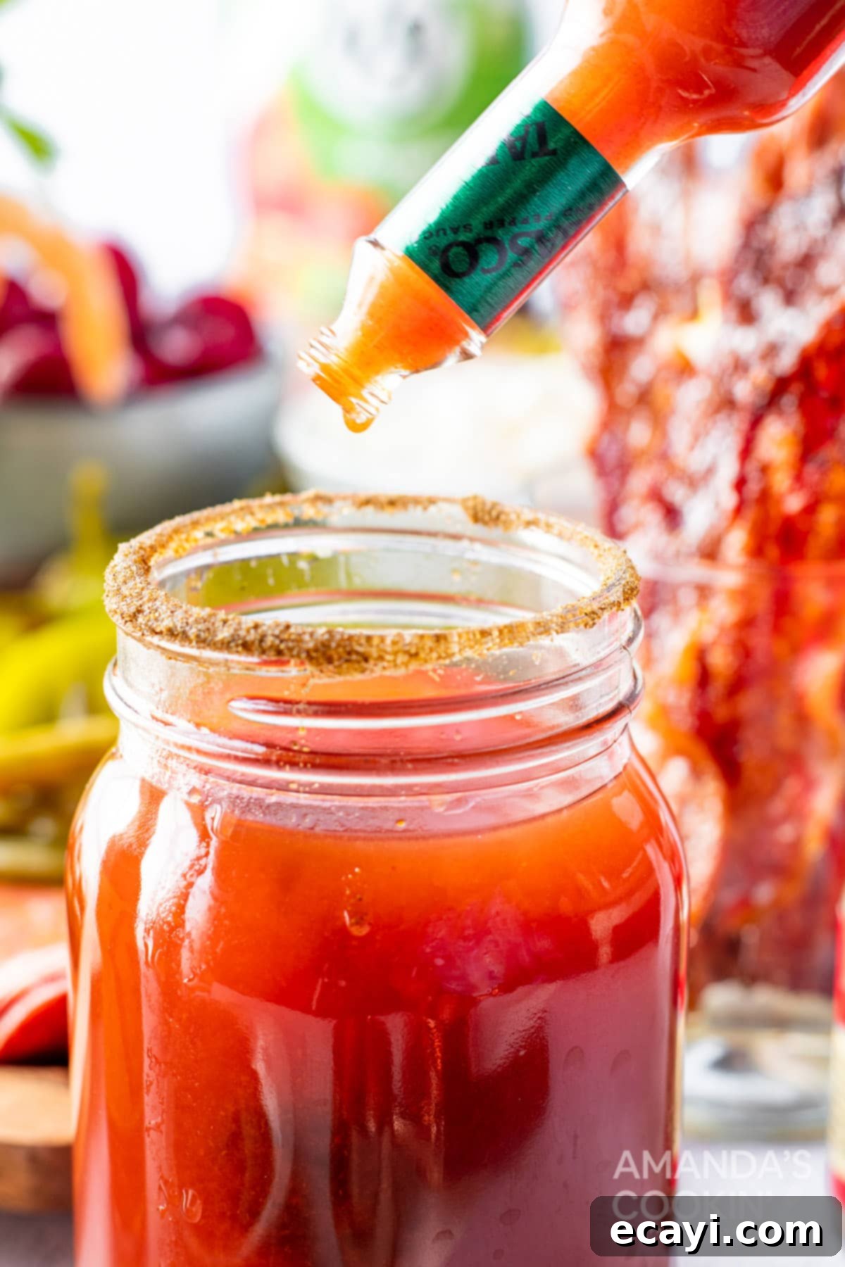 The Curse of Bloody Mary 9 Adding hot sauce to a Bloody Mary glass for extra spice.