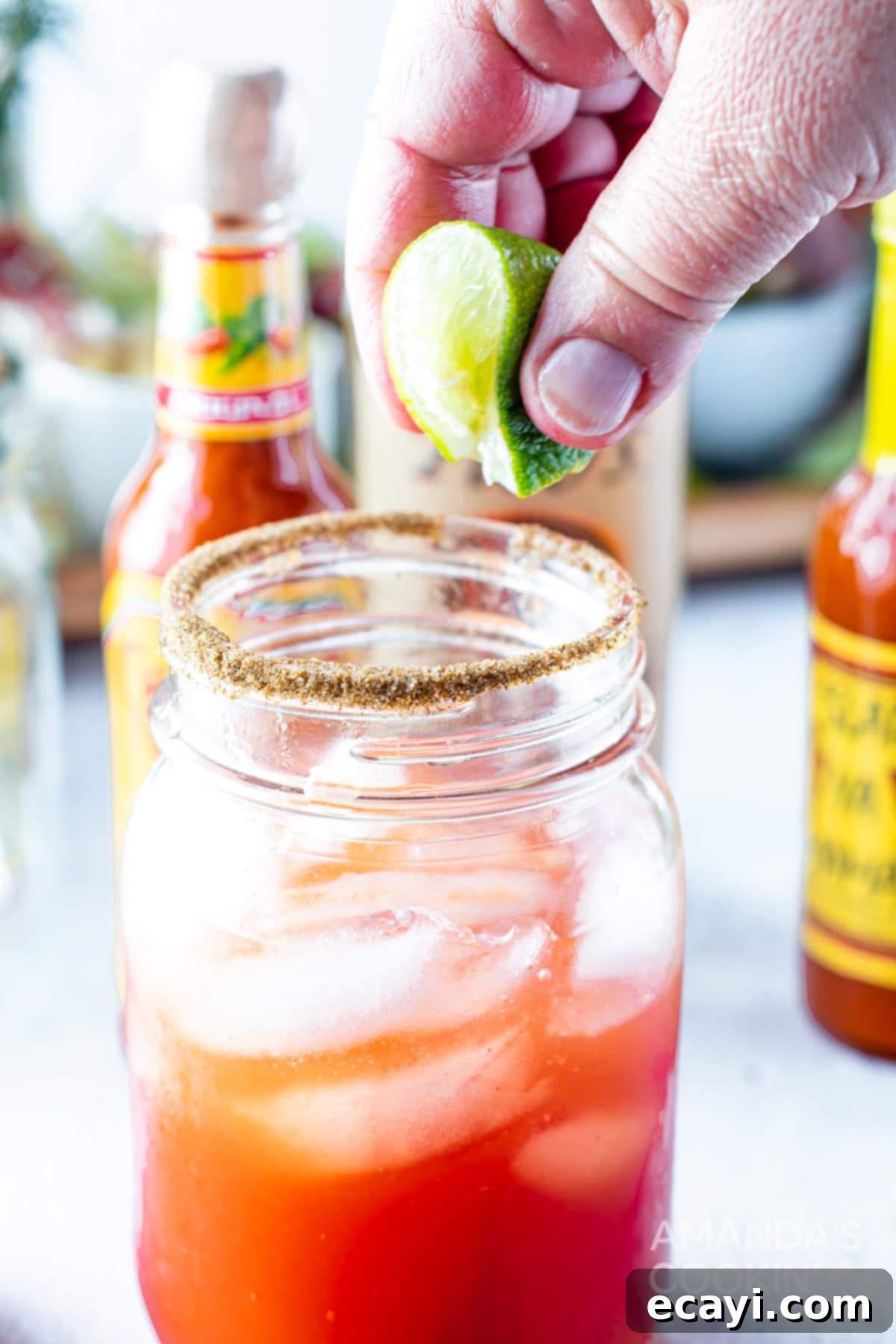 The Curse of Bloody Mary 10 Squeezing fresh lime over a Bloody Mary in a glass.