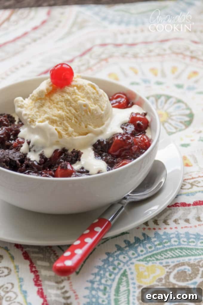 Indulge in this simple 3-ingredient crockpot chocolate cherry cobbler – a quick and delicious slow cooker dessert inspired by Black Forest Cake. #crockpotchocolatecherrycobbler #crockpotdesserts #blackforest #chocolatecobbler #chocolatecherrycobbler #crockpotcobbler #cakemixcobbler #cherrypiefilling #chocolatecakemix #crockpot #slowcooker #chocolatedesserts Delicious and easy crockpot chocolate cherry cobbler topped with vanilla ice cream, perfect for a quick Black Forest inspired dessert