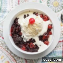 Decadent Slow Cooker Chocolate Cherry Cobbler 5 A delicious bowl of crockpot chocolate cherry cobbler with a dollop of vanilla ice cream
