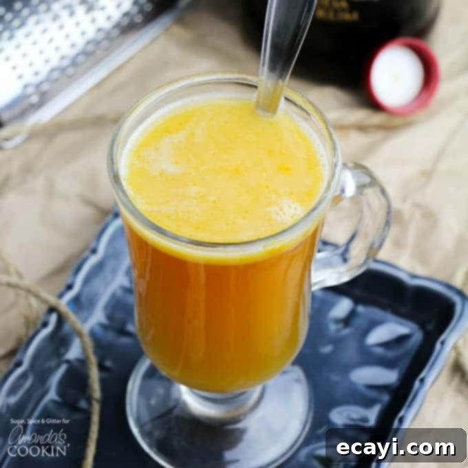 Spiced Pumpkin Dream 2 Hot Buttered Rum in a clear glass mug, garnished with a cinnamon stick.