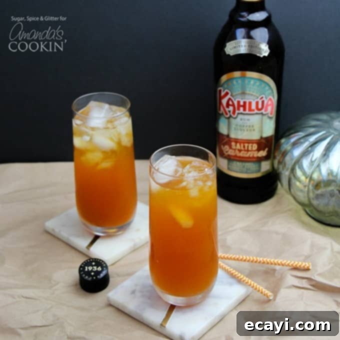 Spiced Pumpkin Dream 3 Two tall caramel pumpkin cocktails with Kahlua in the background, festive for fall.