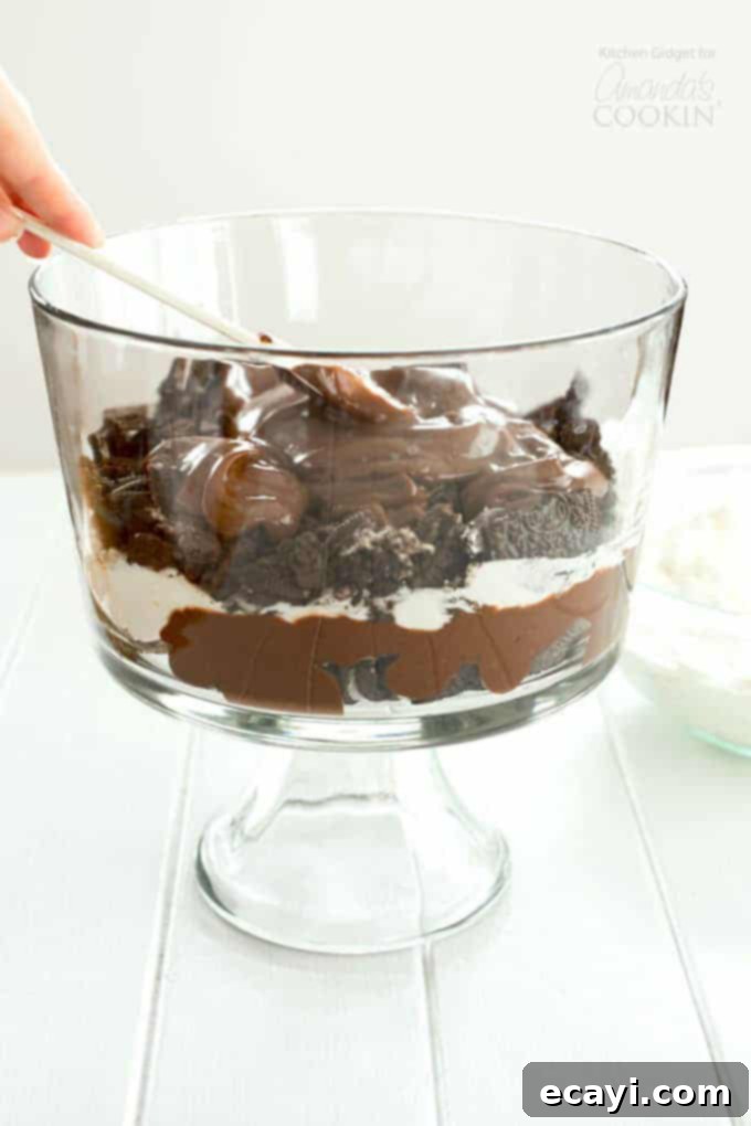Chocolate Lasagna Trifle Spreading a layer of chocolate pudding over Oreos