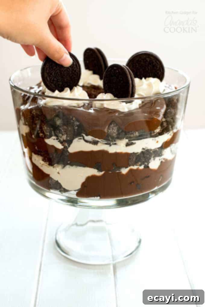 Chocolate Lasagna Trifle Placing an oreo on top of Chocolate Lasagna Trifle