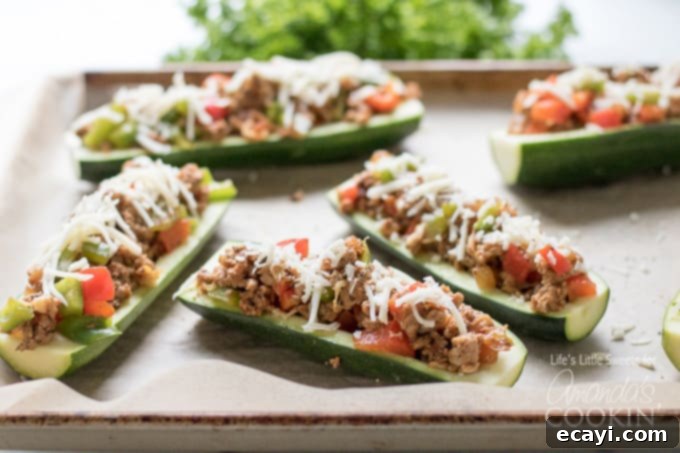 Zucchini Pockets 7 Stuffed zucchini boats arranged on a baking sheet, ready for the oven