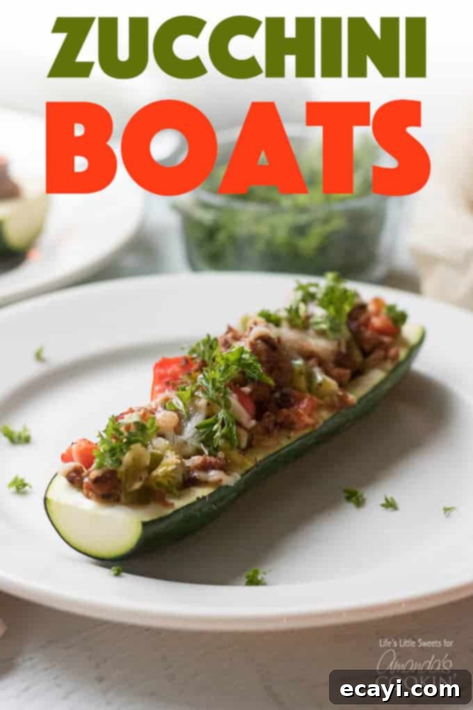 These colorful stuffed zucchini boats are a savory and delicious dinner packed with lean protein and a healthy serving of vegetables. Stuffing zucchini with lean ground turkey, fresh peppers, onions, and grated cheese makes for a tasty low-carb dinner and is a great way to use up all that garden zucchini! #zucchiniboats #stuffedzucchini #zucchinirecipes #lowcarbdinners #lowcarbrecipes #groundturkey #zucchini #amandascookin Stuffed zucchini halves lined up for baking
