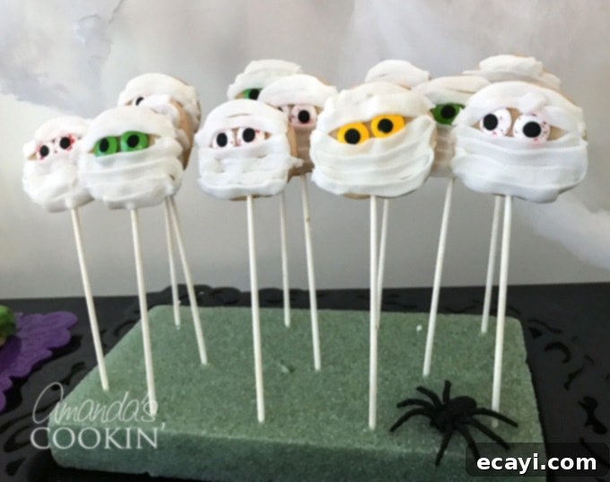 If you need Halloween food ideas for your Halloween party, be sure to check out all these sweet, savory and beverage ideas! Something for everyone. #halloweenrecipes #halloweenfoodideas #halloweenfood #halloweentreats #halloweenpartyfood #mummycookies #mozarellaeyeballs #spidertacodip #spidercookies #ricekrispypumpkins #ricekrispymonsters #dipinapumpkin #halloweenparty mummy cookies
