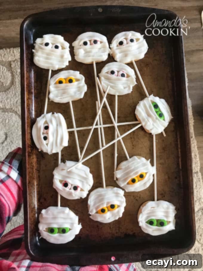 If you need Halloween food ideas for your Halloween party, be sure to check out all these sweet, savory and beverage ideas! Something for everyone. #halloweenrecipes #halloweenfoodideas #halloweenfood #halloweentreats #halloweenpartyfood #mummycookies #mozarellaeyeballs #spidertacodip #spidercookies #ricekrispypumpkins #ricekrispymonsters #dipinapumpkin #halloweenparty mummy cookies