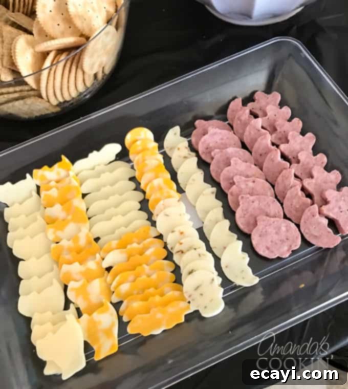 If you need Halloween food ideas for your Halloween party, be sure to check out all these sweet, savory and beverage ideas! Something for everyone. #halloweenrecipes #halloweenfoodideas #halloweenfood #halloweentreats #halloweenpartyfood #mummycookies #mozarellaeyeballs #spidertacodip #spidercookies #ricekrispypumpkins #ricekrispymonsters #dipinapumpkin #halloweenparty cookie cutter cheese and sausage