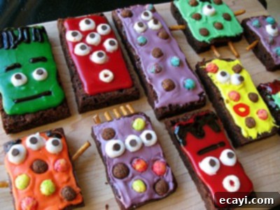If you need Halloween food ideas for your Halloween party, be sure to check out all these sweet, savory and beverage ideas! Something for everyone. #halloweenrecipes #halloweenfoodideas #halloweenfood #halloweentreats #halloweenpartyfood #mummycookies #mozarellaeyeballs #spidertacodip #spidercookies #ricekrispypumpkins #ricekrispymonsters #dipinapumpkin #halloweenparty monster brownie treats