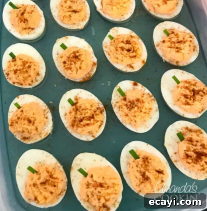 If you need Halloween food ideas for your Halloween party, be sure to check out all these sweet, savory and beverage ideas! Something for everyone. #halloweenrecipes #halloweenfoodideas #halloweenfood #halloweentreats #halloweenpartyfood #mummycookies #mozarellaeyeballs #spidertacodip #spidercookies #ricekrispypumpkins #ricekrispymonsters #dipinapumpkin #halloweenparty pumpkin deviled eggs