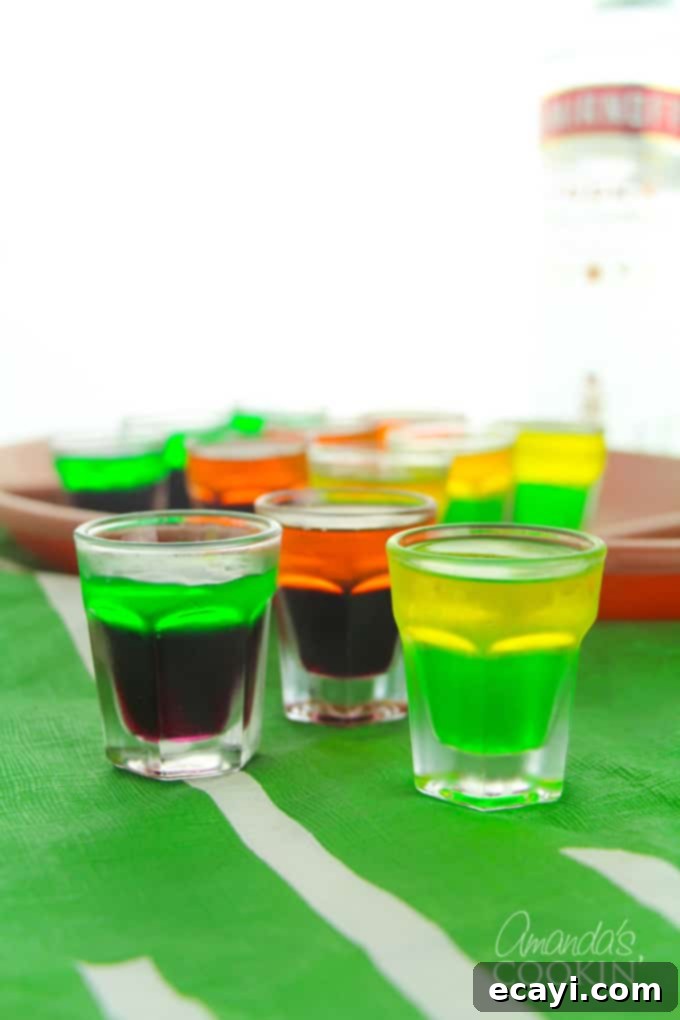 Love tailgating? Portable football jello shots are perfect for it! Watch the game at home or the stadium, these football jello shots are great! #jelloshots #footballjelloshots #footballteamjelloshots #footballfood #tailgating #tailgatingcocktails #sponsored #IbottaPartner #howtomakejelloshots #amandascookin Football themed jello shots in various colors, perfect for a game day spread