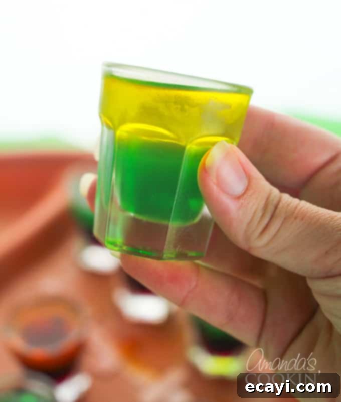 Kickoff Your Party: Football Jello Shots 5 A vibrant green and yellow jello shot, representing Green Bay Packers colors