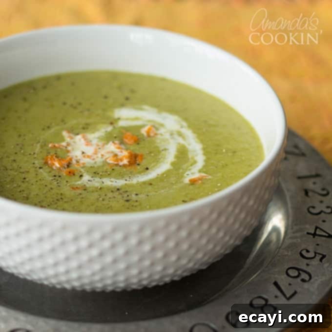 Slow Cooker Autumn Butternut Delight 4 A bowl of creamy asparagus soup garnished with fresh cream and herbs