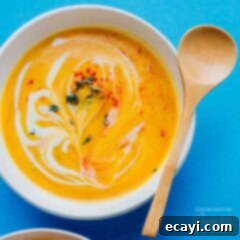 Slow Cooker Autumn Butternut Delight 5 creamy cauliflower soup in a bowl with wooden spoon